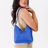 Astro Blue Small | Model wearing petite shoulder bag with adjustable strap and magnetic snap closure