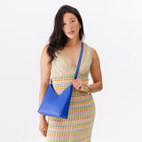 Astro Blue Small | Model wearing petite shoulder bag with adjustable strap and magnetic snap closure