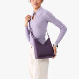 Empire Small | Model wearing petite shoulder bag with adjustable strap and magnetic snap closure