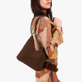 Stagecoach Small | Model wearing petite shoulder bag with adjustable strap and magnetic snap closure