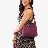Superbloom Small | Model wearing petite shoulder bag with adjustable strap and magnetic snap closure