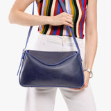 Cobalt Medium | Model wearing a leather Crossbody with a flap and magnetic closure
