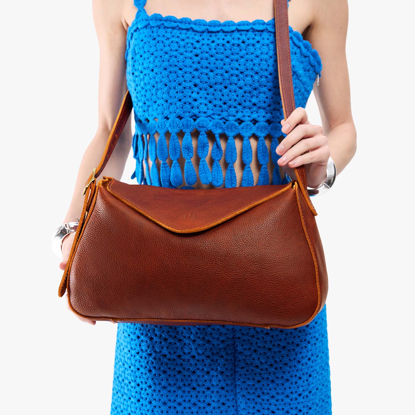 Nutmeg*Medium | Model wearing a leather Crossbody with a flap and magnetic closure