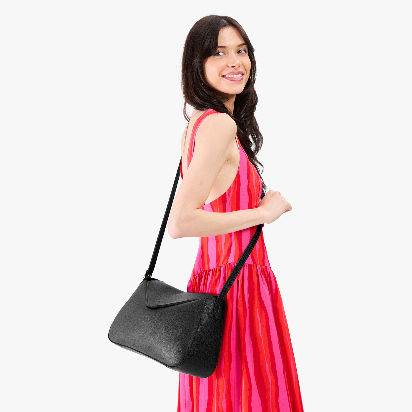 Pebbled--black*Medium | Model wearing a leather Crossbody with a flap and magnetic closure
