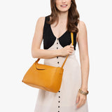 Sunshine Medium | Model wearing a leather Crossbody with a flap and magnetic closure