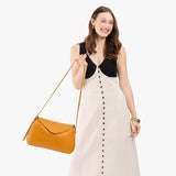 Sunshine Medium | Model wearing a leather Crossbody with a flap and magnetic closure
