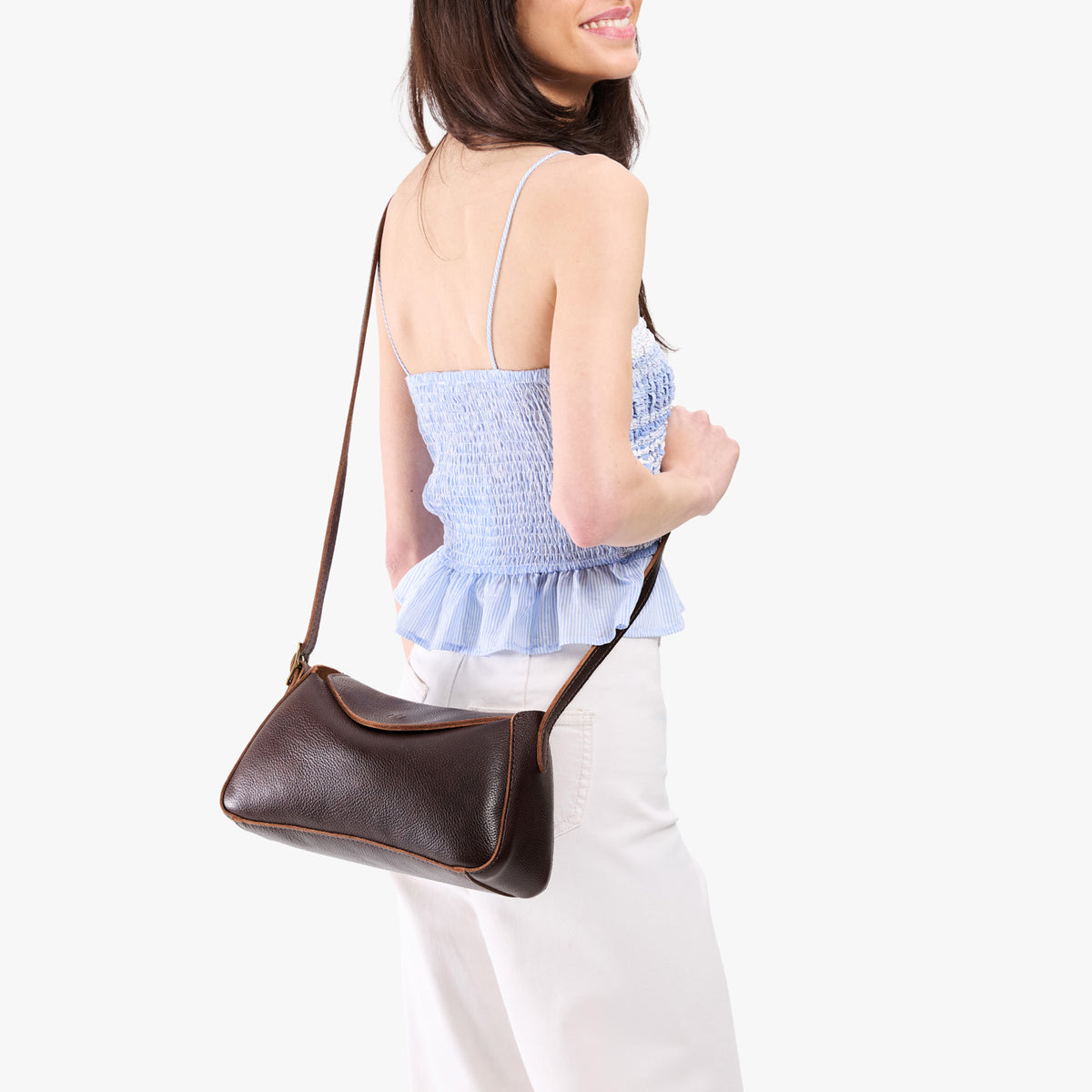 Coldbrew*Small | Model wearing a leather Crossbody with a flap and magnetic closure