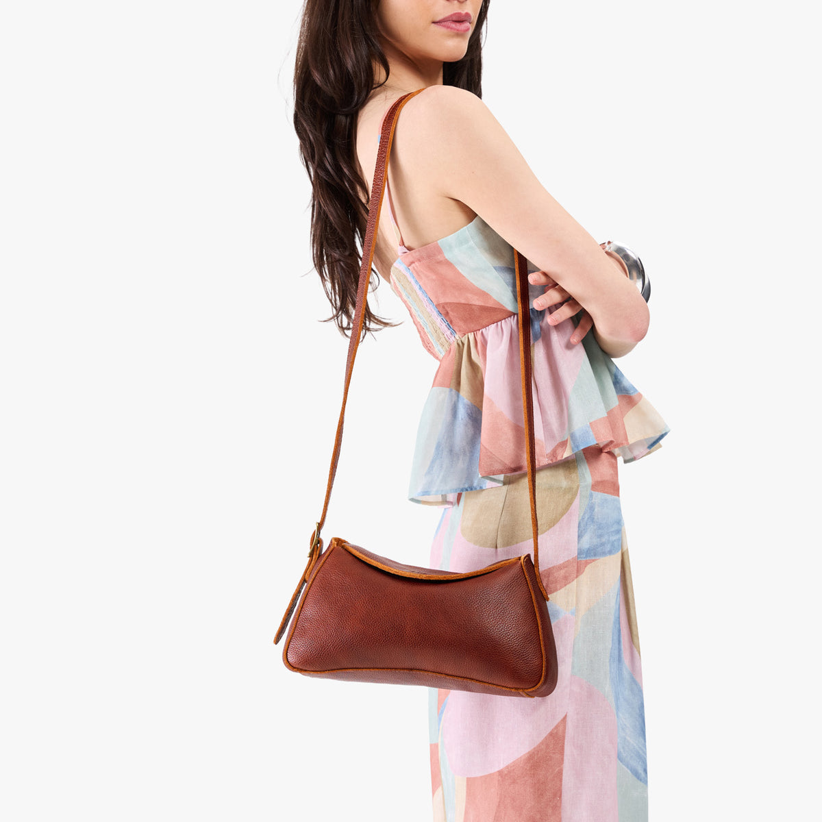 Nutmeg*Small | Model wearing a leather Crossbody with a flap and magnetic closure