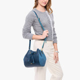 Caspian | Model wearing bucket bag with cinched drawstring closure