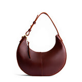 Cognac Small | Crescent shaped shoulder bag with zipper closure and adjustable strap