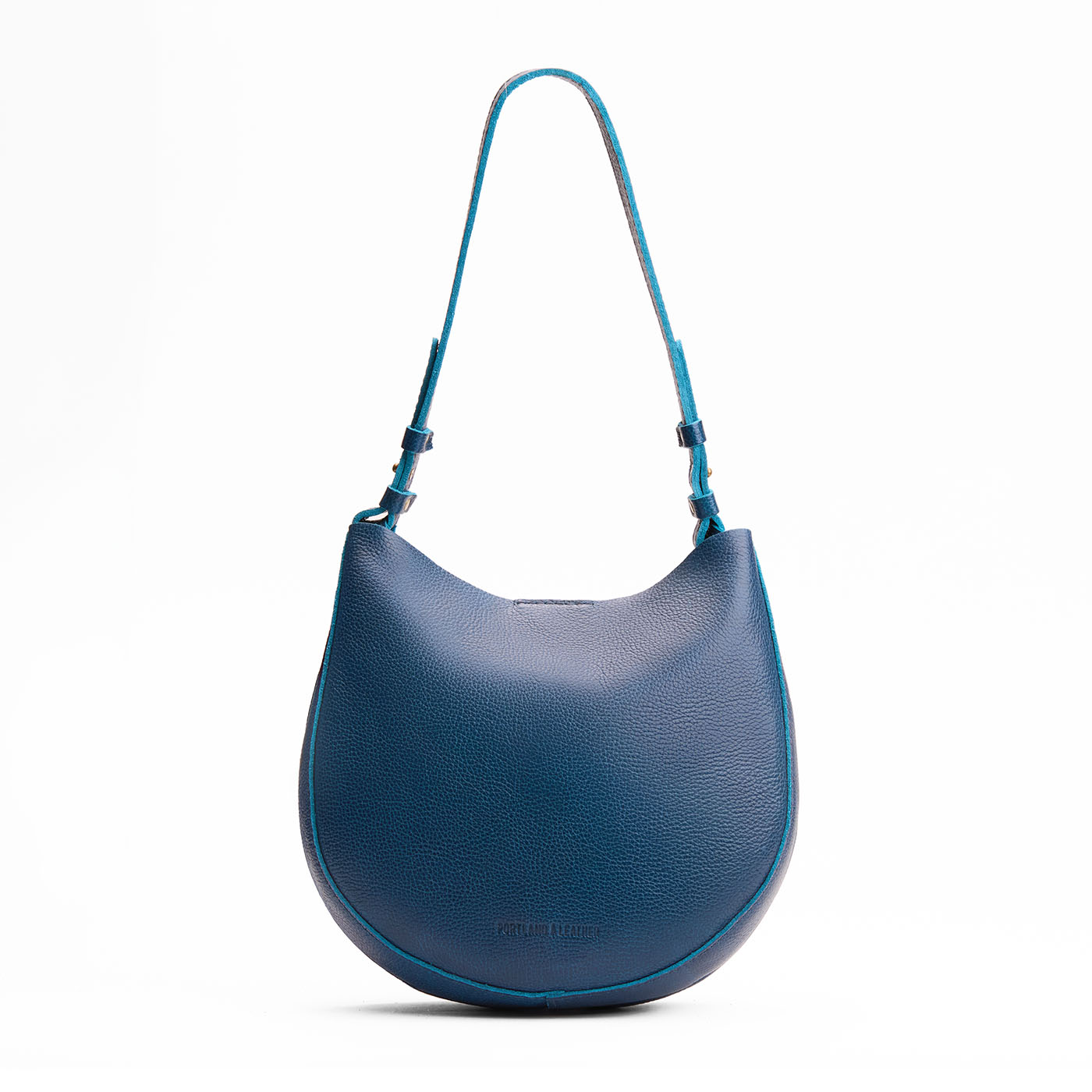 Caspian*Medium | Rounded shoulder bag with adjustable strap on a white background