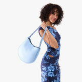Skyway Medium | Model carrying round leather purse with adjustable shoulder strap