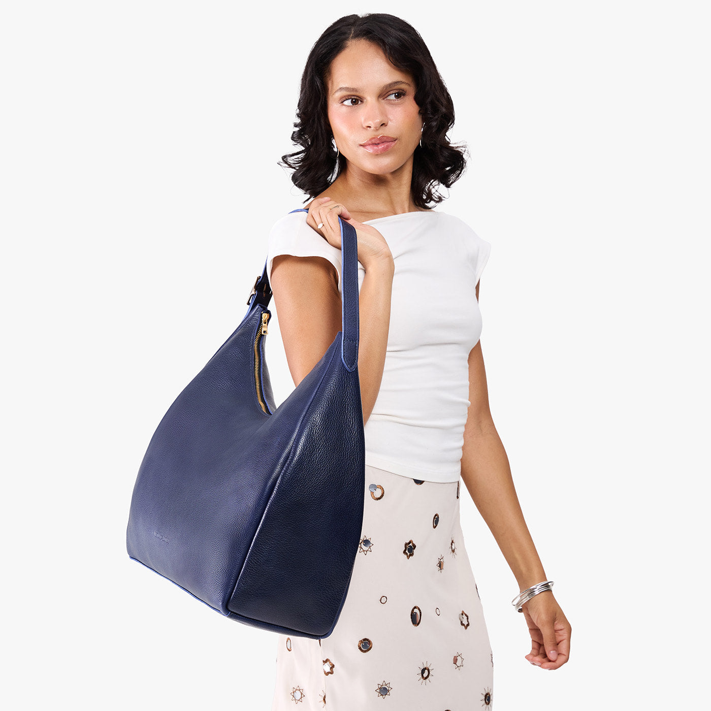 Cobalt*Oversized | Model carrying U-shaped, flat-bottomed leather shoulder bag with adjustable strap