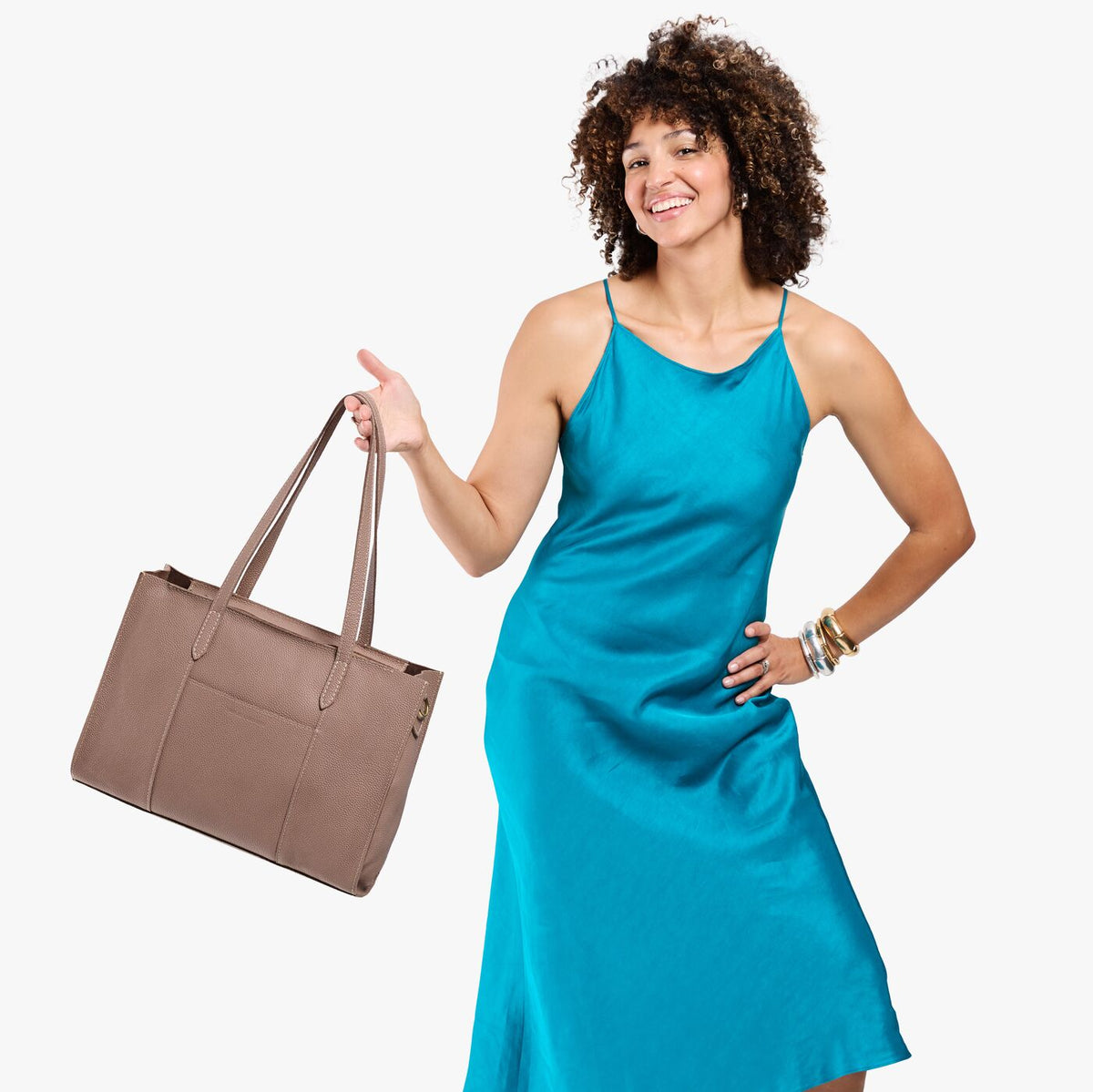 Sparrow*Oversized East/West | Model holding structured wide tote bag with overlapping panels and crossbody strap