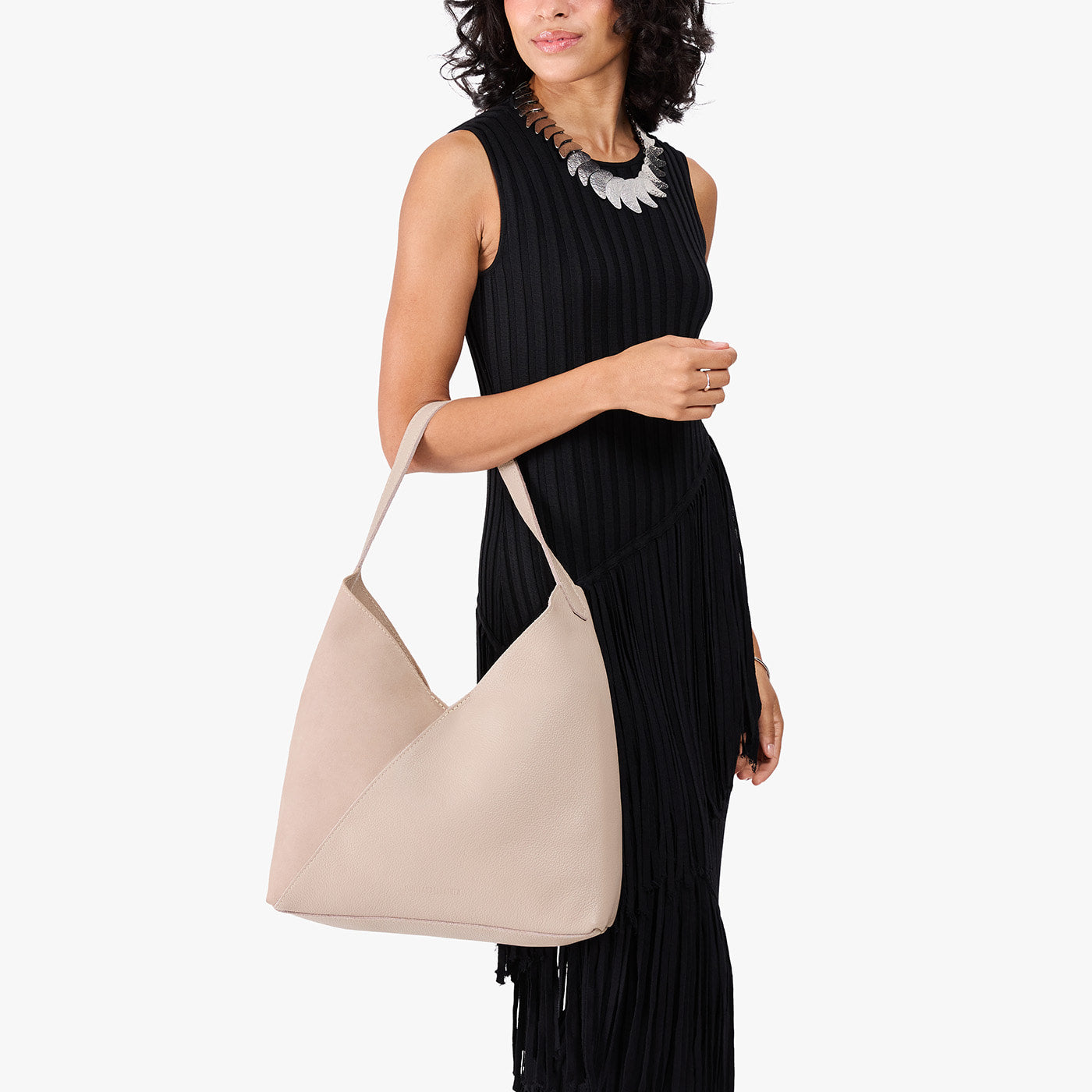 Toasted Oat*Oversized | Model holding large shoulder bag with adjustable strap and magnetic snap closure