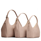 Taupe | Size comparison image of oversized, large, and medium u-shaped, flat-bottomed leather shoulder bags with adjustable strap