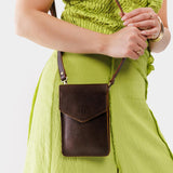 Coldbrew | Model wearing slim, phone-shaped crossbody purse with magnetic closure