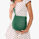 Bacalar | A model wearing a rounded children's adjustable crossbody bag