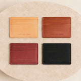 Naturale | Group of wallets arranged in a 2x2 grid on a round beige stone slab