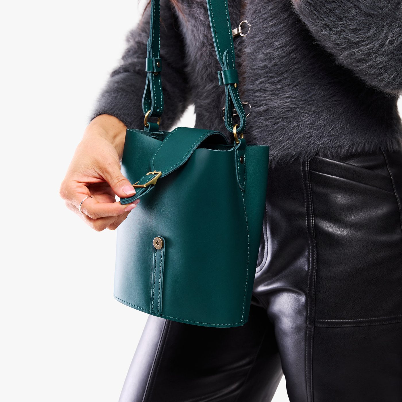 Harbor | Model wearing leather bucket shoulder bag with adjustable strap and magnetic closure 