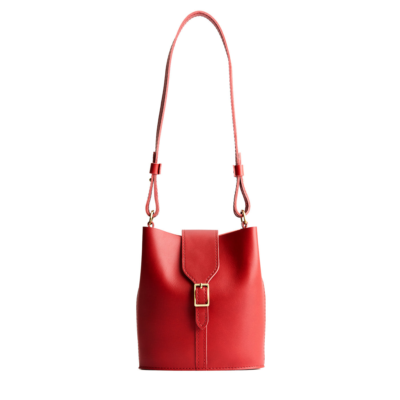 Ruby | Leather bucket shoulder bag with adjustable strap and magnetic closure on a white background