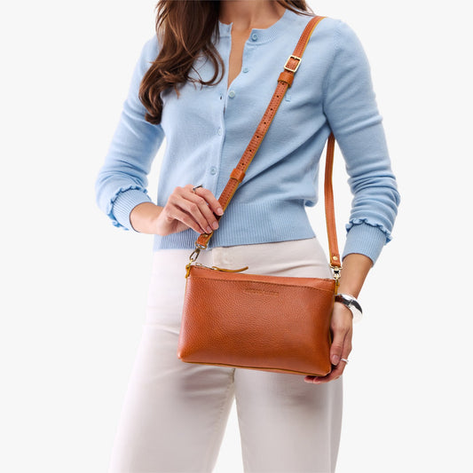 Sienna*Small | Model holding a zip top crossbody bag with detachable strap