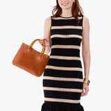 Sienna Large | Model wearing a mid-size tote purse with  structured leather handles and crossbody strap