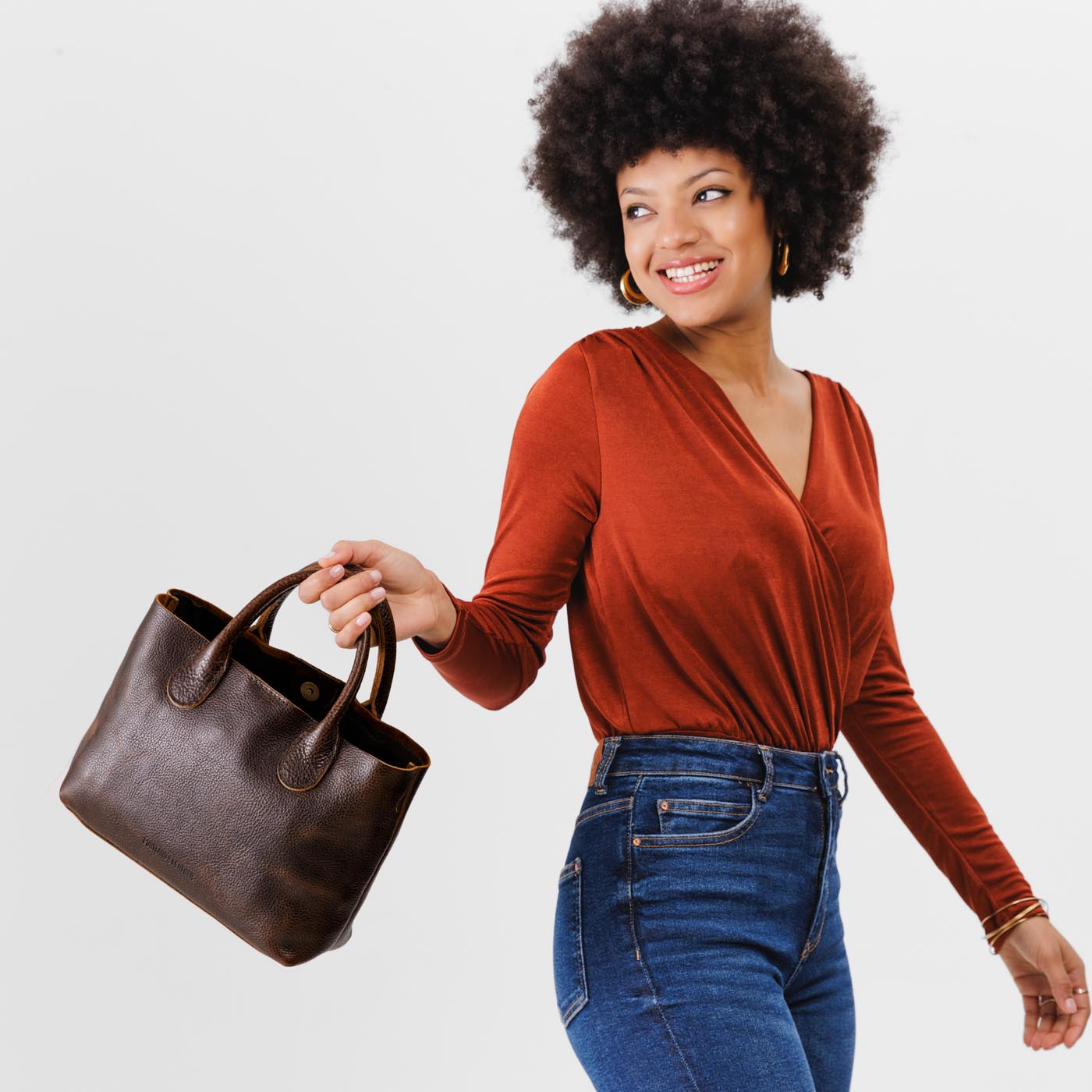 Coldbrew*Large | Model holding mid-size tote purse with  structured leather handles and crossbody strap