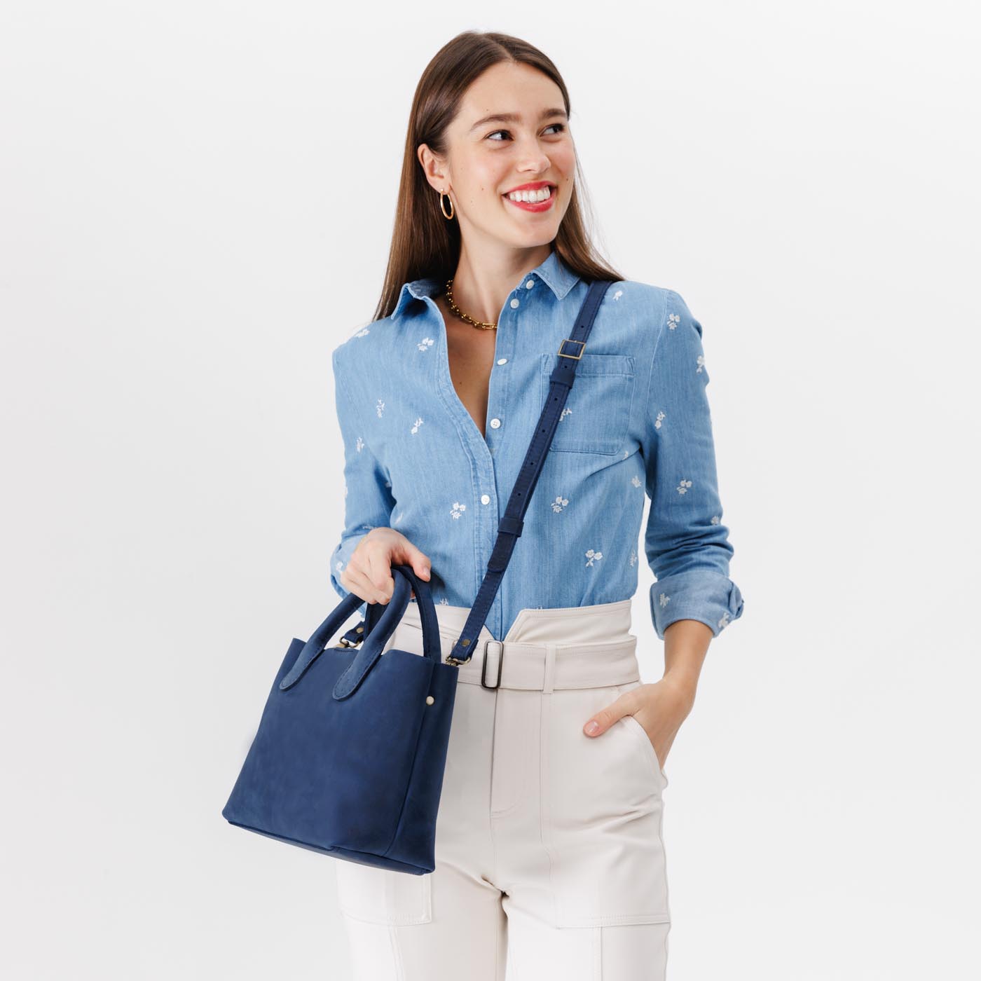 Deep Water*Large | Model holding mid-size tote purse with  structured leather handles and crossbody strap
