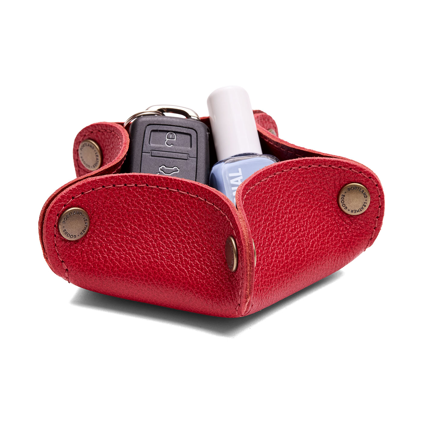 Cherry | Star-shaped foldable leather tray with snap-button corners holding nail polish and car keys