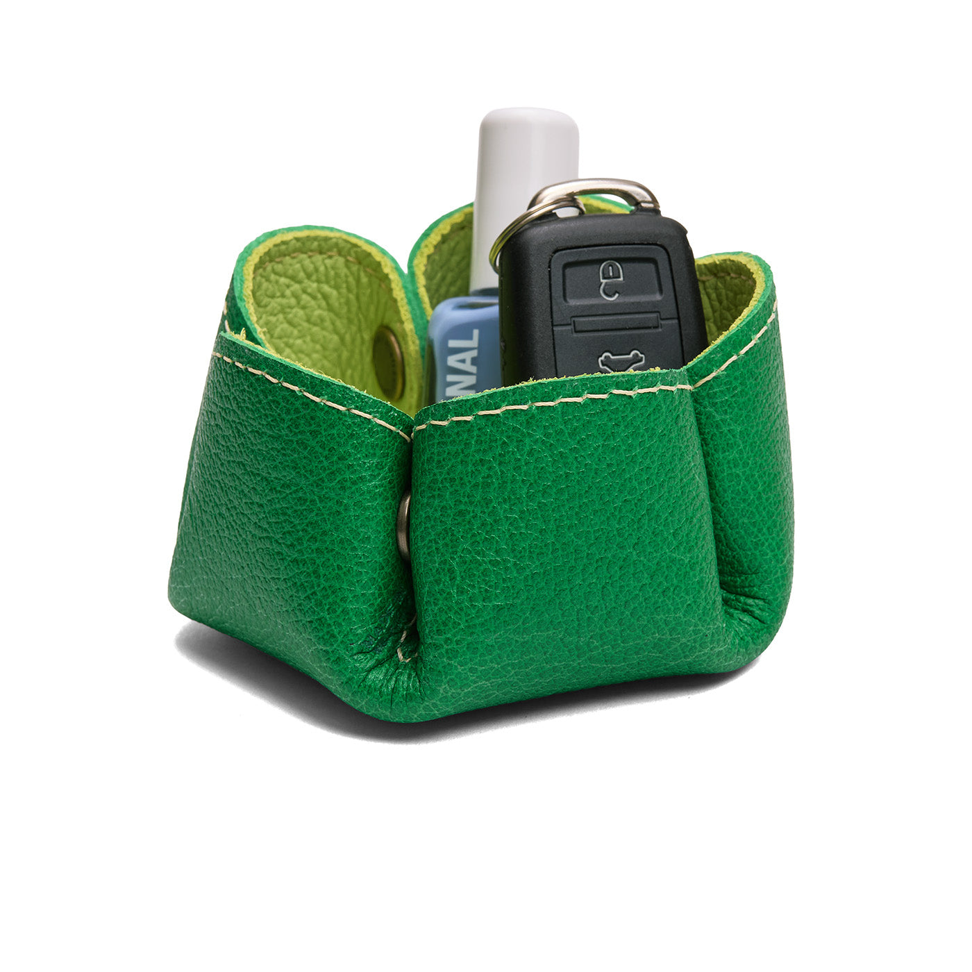 Shadow Lime | Flower-shaped foldable leather tray with snap-button corners holding nail polish and car keys