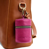 Cosmo | Cylindrical shaped pouch with a gold zipper and swivel lobster claw clasp on a bag