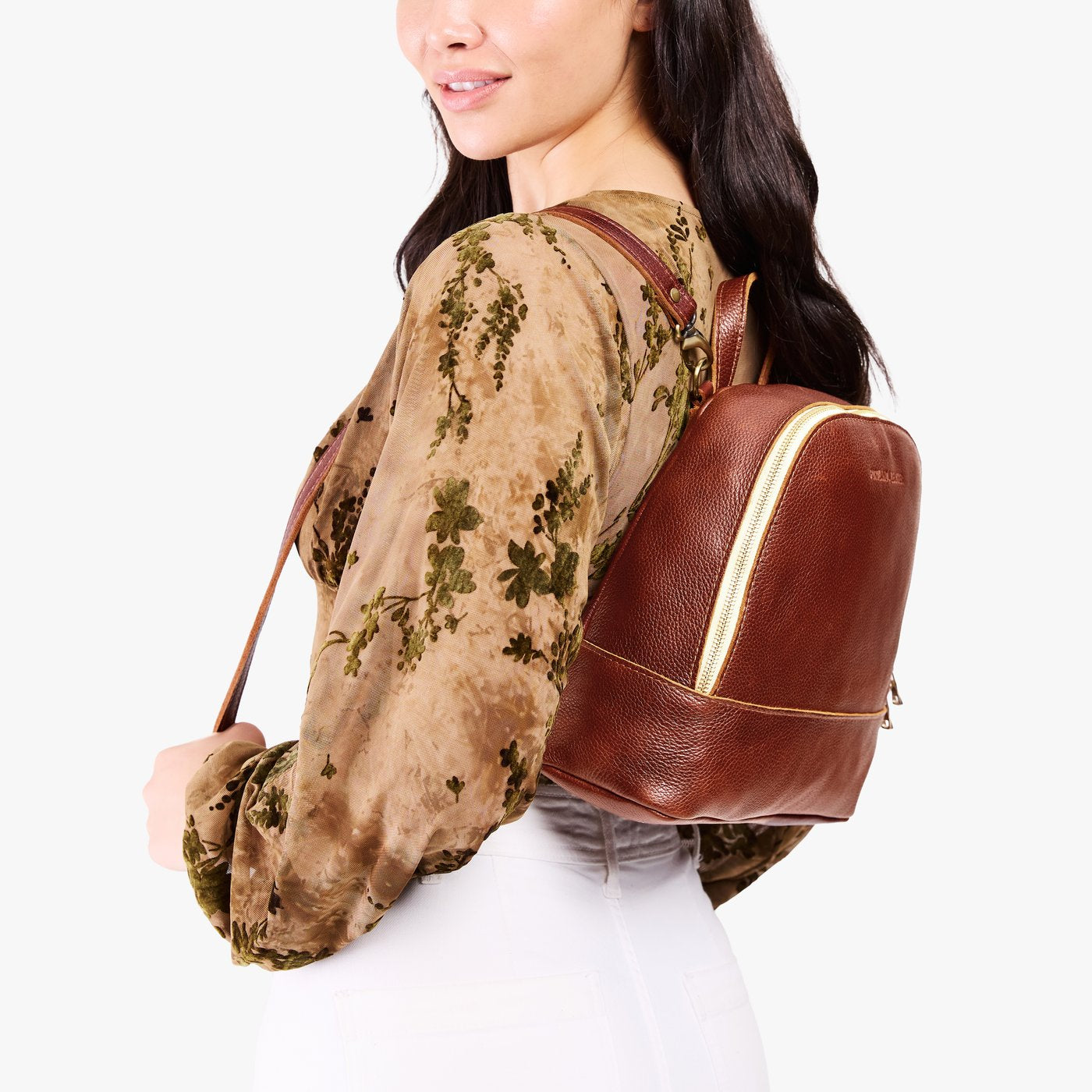 Nutmeg | Model wearing leather backpack with debossed Portland Leather logo on front