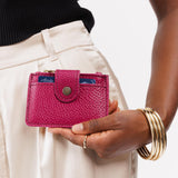Cosmo | Model holding compact wallet with snap closure and zippered pouch