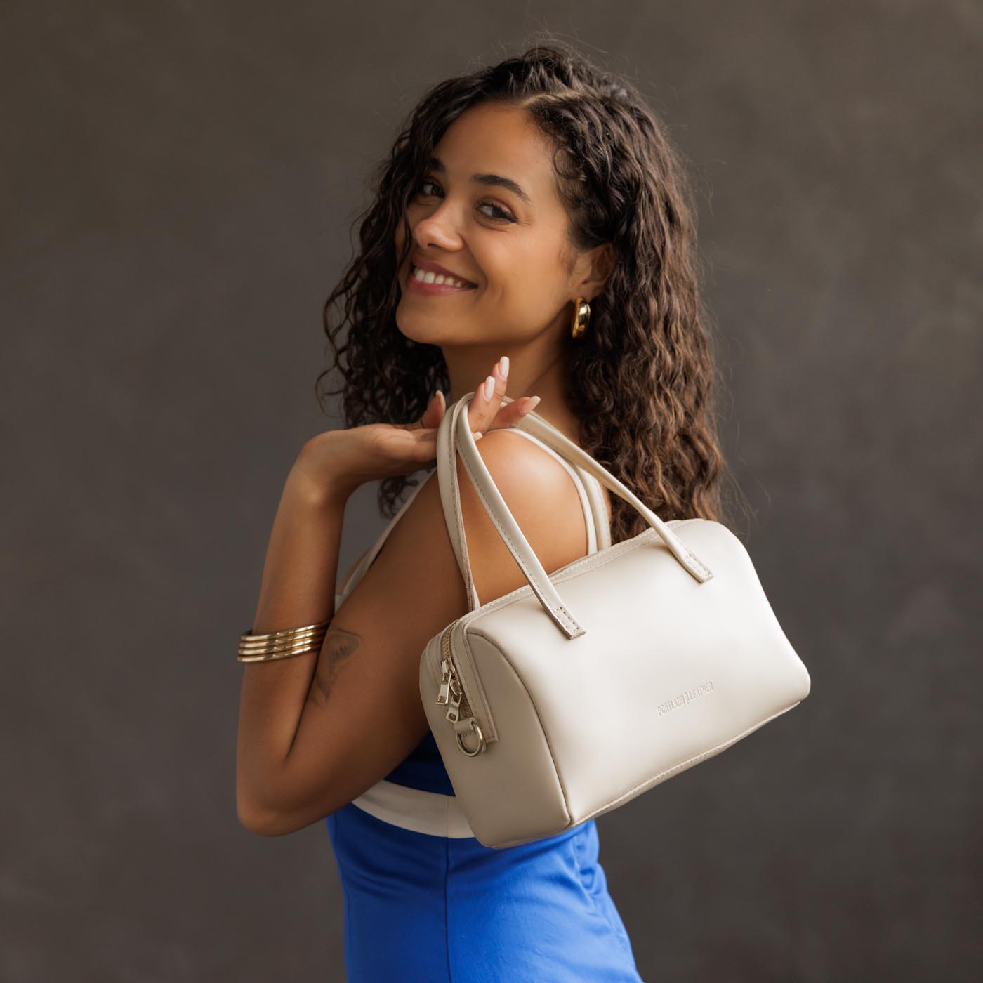 Bone*Large | Model wearing mini duffle shaped handbag with crossbody strap