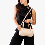 Moonflower Large | Model holding mini duffle shaped handbag with crossbody strap