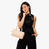 Moonflower Large | Model holding mini duffle shaped handbag with crossbody strap