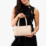 Moonflower Large | Model holding mini duffle shaped handbag with crossbody strap