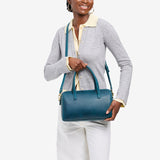 Westward Blue Oversized | Model holding mini duffle shaped handbag with crossbody strap