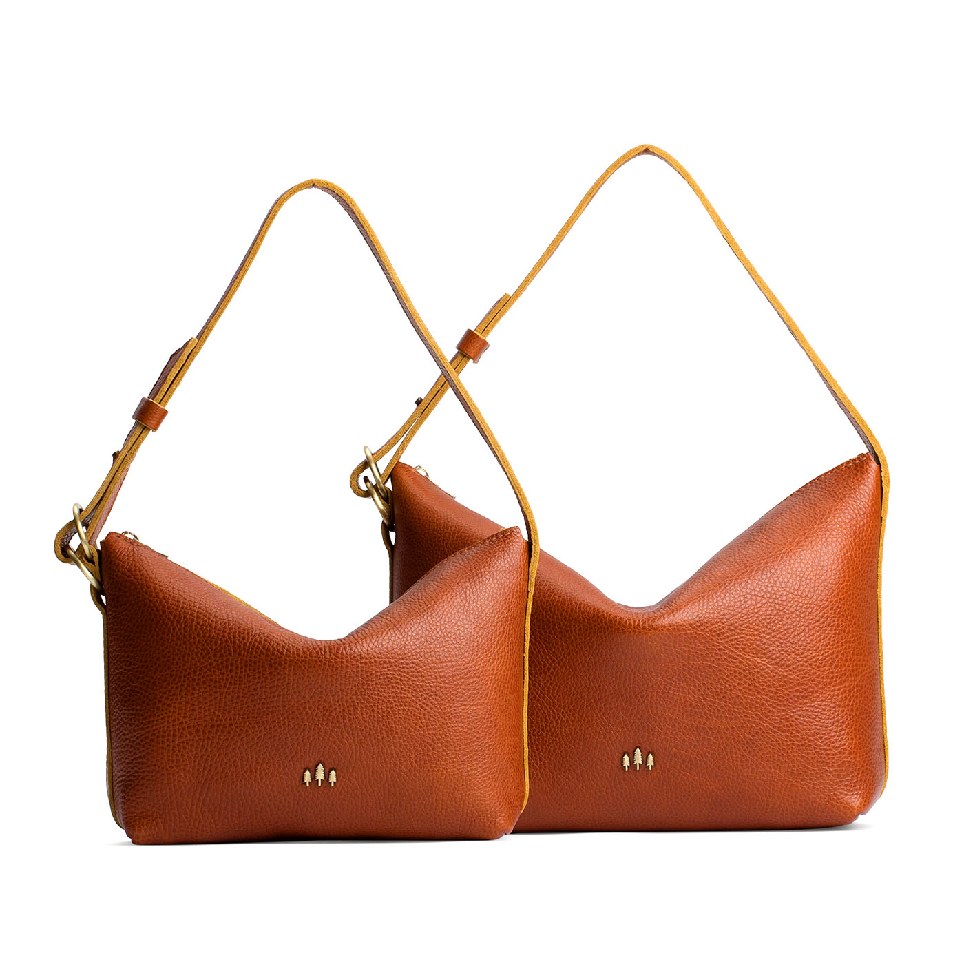 Sienna | Size comparison shot of small and large slouchy leather shoulder bags with zipper opening and three metal tree emblems