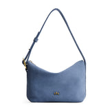 Denim Small | Slouchy Shoulder Bag that has a zipper opening and three metal tree emblems on a white background