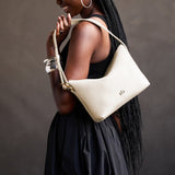 Pebbled Bone Small | Petite slouchy leather shoulder bag with zipper opening and three metal tree emblems