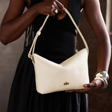 Pebbled Bone Small | Petite slouchy leather shoulder bag with zipper opening and three metal tree emblems