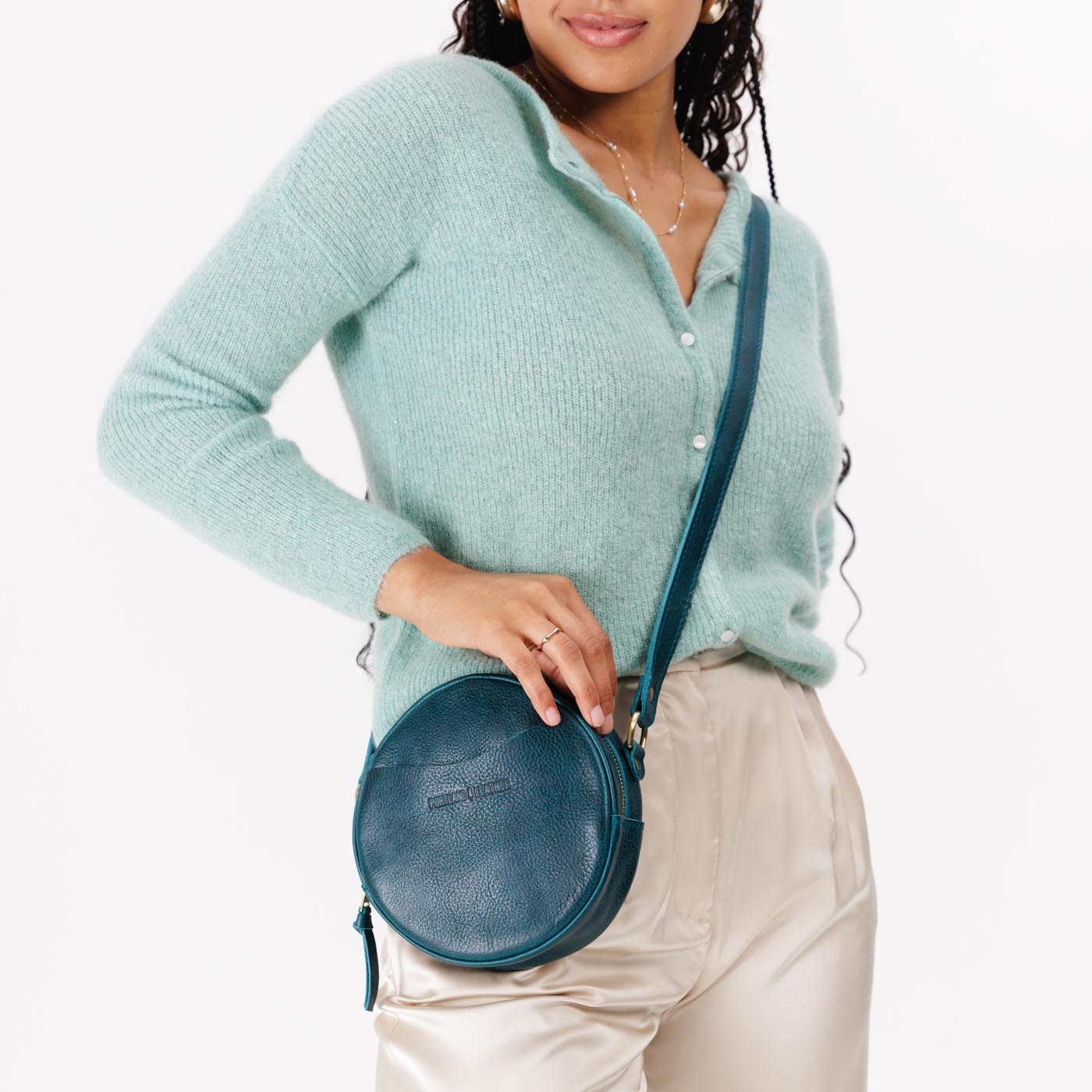 Lagoon*Small | Model wearing circle shaped crossbody bag with top zipper