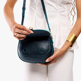 Boreal Small | Model wearing a petite leather Crossbody with a flap and magnetic closure