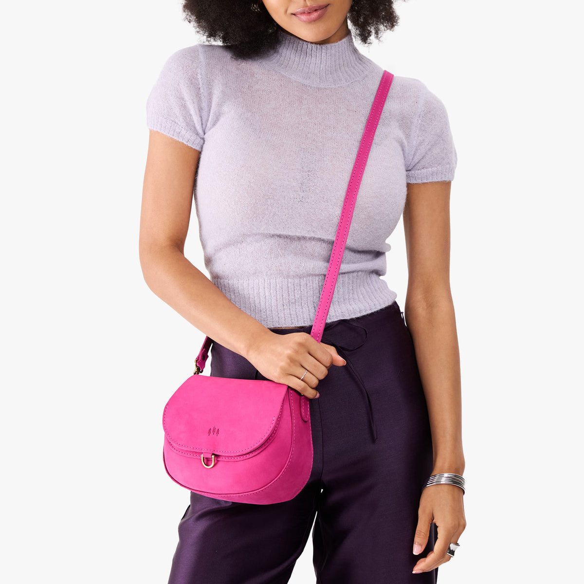 Royalty*Small | Model wearing a leather Crossbody with a flap and magnetic closure