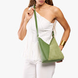 Dryland Green Small | Model carrying petite shoulder bag with adjustable strap and magnetic snap closure