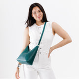 Sea Glass Small | Model wearing petite shoulder bag with adjustable strap and magnetic snap closure