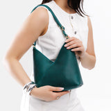 Sea Glass Small | Model wearing petite shoulder bag with adjustable strap and magnetic snap closure