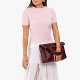 Cabernet Small | Model wearing a convertible tote clutch crossbody